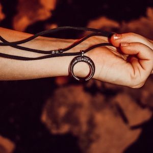 Half moon silver chocker with black leather straps